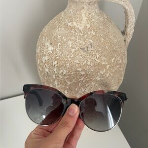 Chanel Sunglasses featuring a chic tortoiseshell/burgundy frame